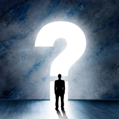 Silhouette of a male person in front of a question mark